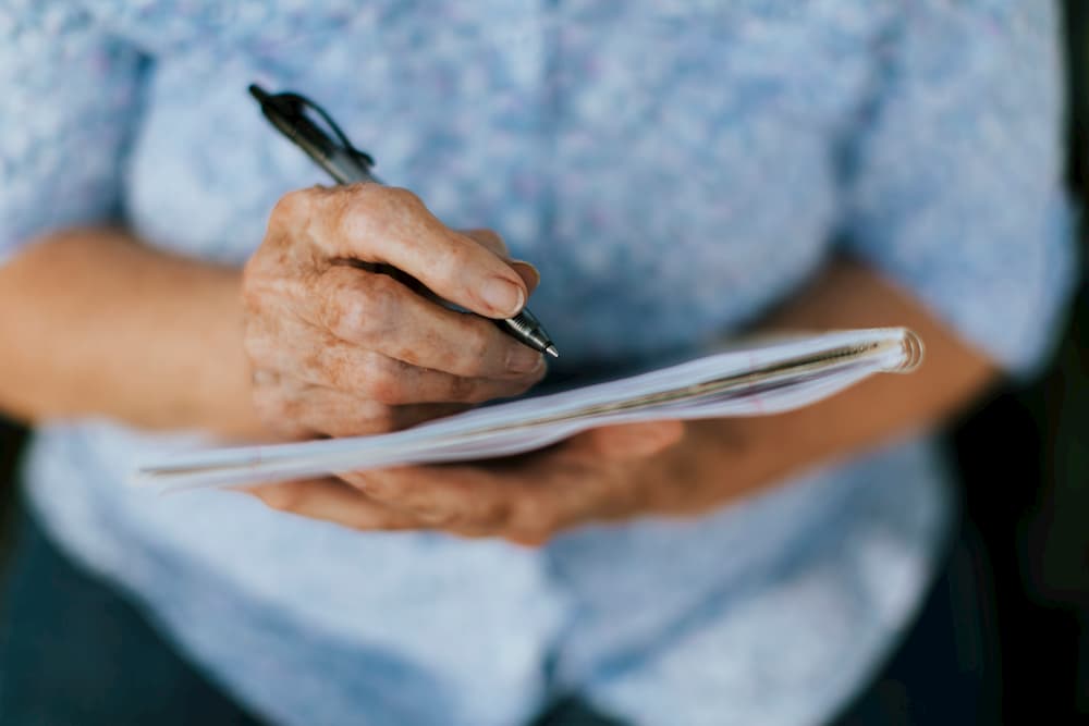 Elderly woman writing her will