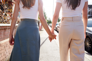 Two women holding hands in relationship